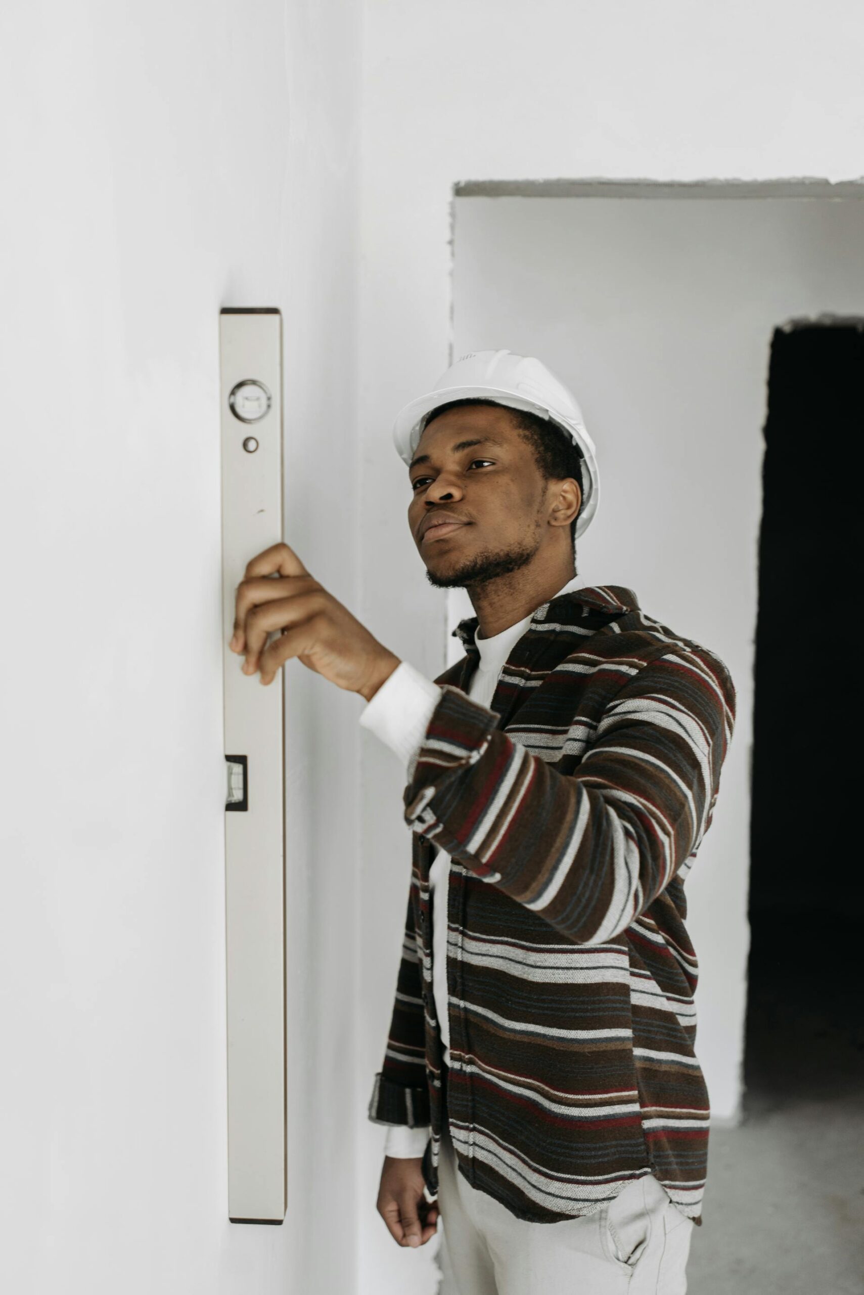 Black man measuring wall